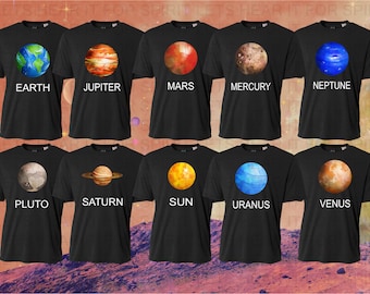 May include: Ten black t-shirts with a white graphic of each planet in our solar system. The planets are depicted in watercolor style. The shirts are labeled with the name of each planet: Earth, Jupiter, Mars, Mercury, Neptune, Pluto, Saturn, Sun, Uranus, and Venus.