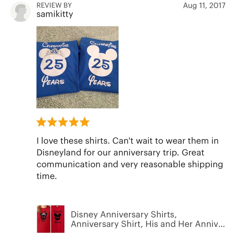 May include: Two blue t-shirts with white text and a white Mickey Mouse head design. The text on the shirts says "Celebrating 25 Years".