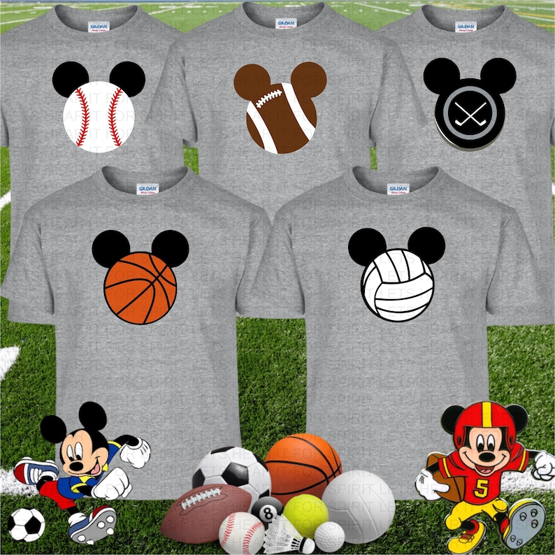 May include: Gray t-shirts with sports-themed Mickey Mouse designs. The designs include a baseball, football, hockey puck, basketball, and volleyball. Additional sports balls and Mickey Mouse figures are at the bottom of the image.