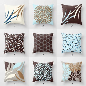 Blue, brown, gray throw pillows with floral and geometric designs