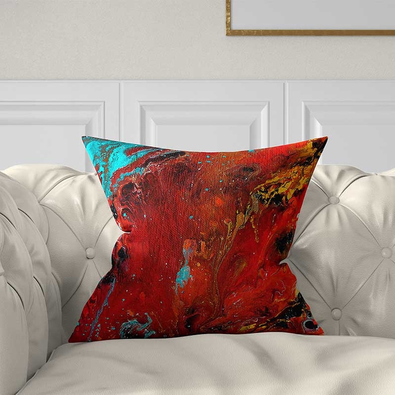 red and teal throw pillow with abstract art design