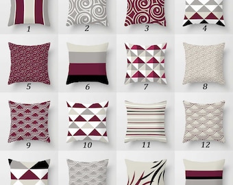 May include: A collection of sixteen square throw pillows featuring various geometric, striped, and abstract patterns in a color palette of burgundy, black, white, and gray. Each pillow is numbered from one to sixteen, displaying distinct designs.