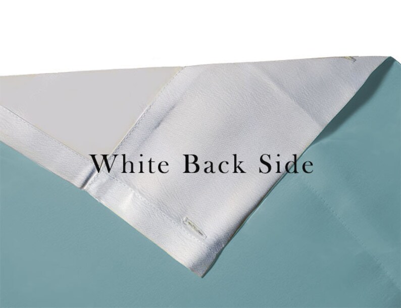 May include: Close-up of a fabric with a white back side and a light blue front side. The text "White Back Side" is printed on the white side.