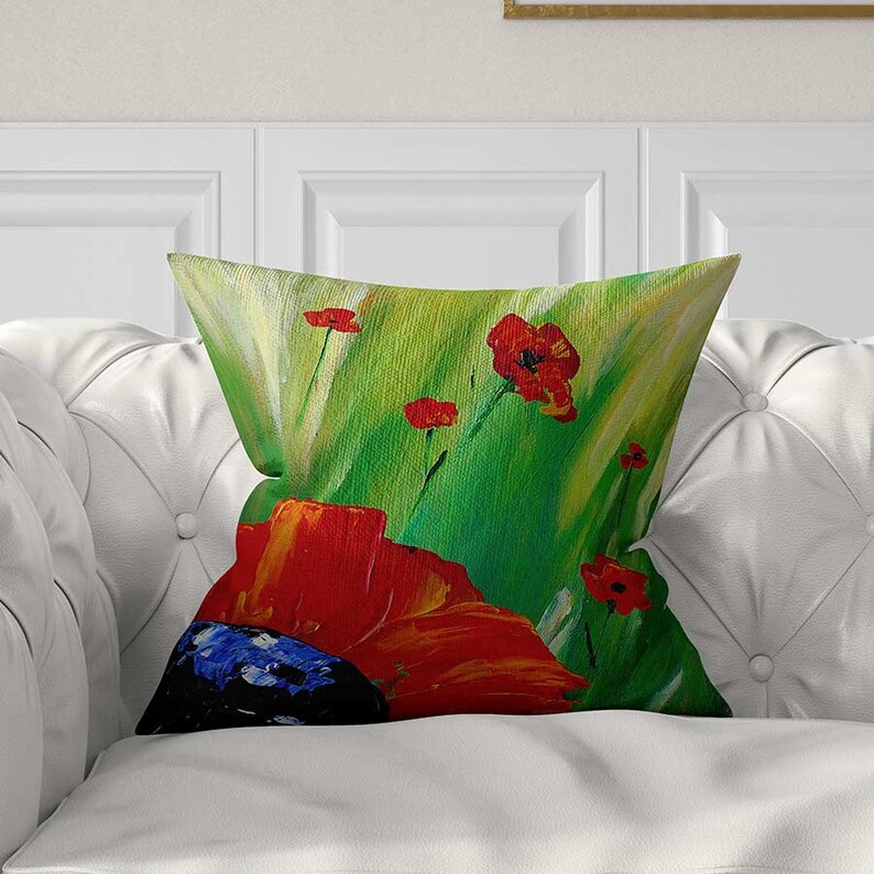 decorative pillow with large red poppies art on green grass