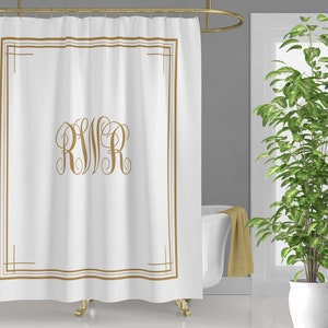 May include: White shower curtain with a gold frame and the monogram "RWR" in a script font.