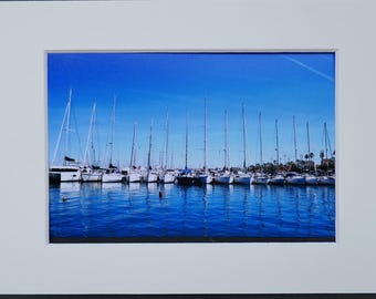 Photography of a Row of Sailboats docked at a Marina