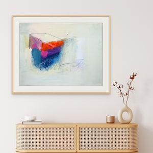 May include: Abstract painting in a wooden frame with a colourful geometric shape in the centre. The background is a light blue with hints of white and purple.