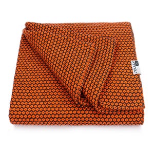 May include: Folded orange and black patterned blanket. The blanket has a repeating dot pattern and a tag that reads "SOULLY 150". The blanket is made of a soft, textured material.