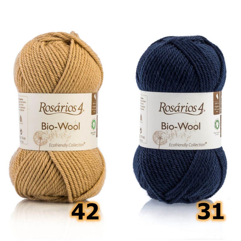 May include: Two skeins of Ros&aacute;rios 4 Bio-Wool yarn, one in tan and one in navy blue. Each label features the text Ros&aacute;rios 4 Bio-Wool Ecofriendly Collection. The tan skein is marked with the number 42 and the navy blue skein with 31.
