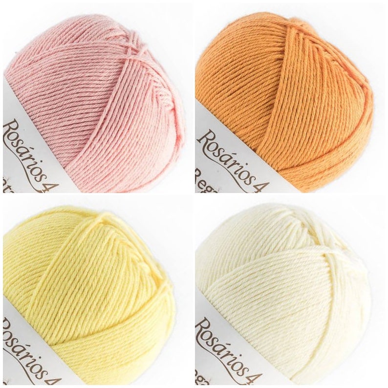 May include: Four balls of yarn in pastel pink, orange, light yellow, and cream. Each ball features a white paper band with the text Ros&aacute;rios 4 printed in black. The yarn is wound into a round shape, displaying a smooth, twisted fiber texture.