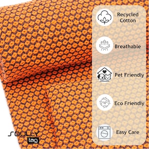 May include: Close-up of a textured orange and navy blue fabric. The fabric is made of recycled cotton, breathable, pet-friendly, eco-friendly, and easy care. The brand name "SOULLY tag" is visible in the bottom left corner.