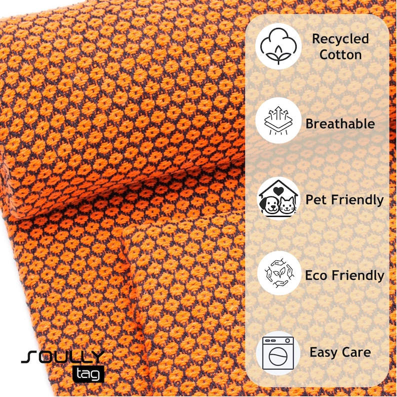 May include: Close-up of a textured orange and navy blue fabric. The fabric is made of recycled cotton, breathable, pet-friendly, eco-friendly, and easy care. The brand name "SOULLY tag" is visible in the bottom left corner.