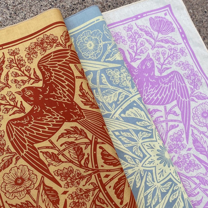 May include: Three fabric bandanas with a floral and bird design. The bandanas are in shades of brown, blue, and purple.