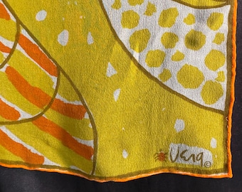 May include: A vintage silk scarf with a vibrant abstract design. The scarf features yellow, orange, and white patterns with an orange border. The scarf has the signature "Vera" in the corner.