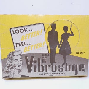 May include: Vintage Vibrosage electric massager box with a yellow and gray design. The box features text that reads "Look Better! Feel Better!" and "Use Daily." The box also has illustrations of a woman and a couple.