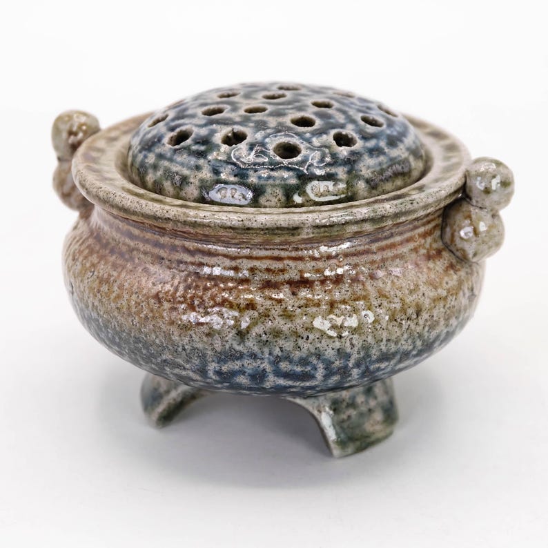 Front view of Mashiko yaki tripod incense burner, natural salt glaze with rustic texture and organic blue brown color
