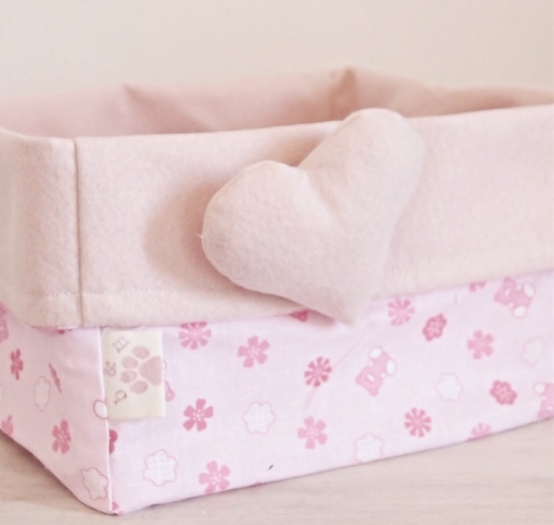 Basket of cloth-carrying diapers with pink heart.