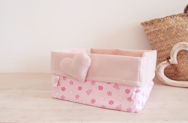 Basket of cloth-carrying diapers with pink heart.