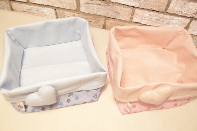 Basket of cloth-carrying diapers with pink heart.