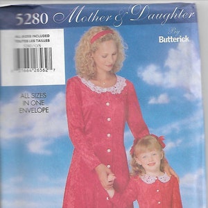 May include: A red dressmaking pattern titled "Mother & Daughter" by Butterick. The pattern features a woman and a young girl wearing matching red dresses with white lace collars and button closures. The text "ALL SIZES IN ONE ENVELOPE" is visible.