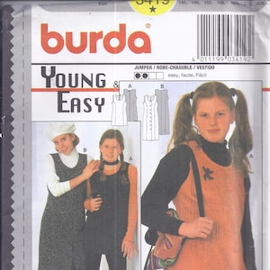 May include: A Burda Young & Easy sewing pattern featuring jumper and vest designs. The cover shows young girls modeling the garments. The pattern includes instructions for seams and hems. The color palette includes orange, black, and gray.