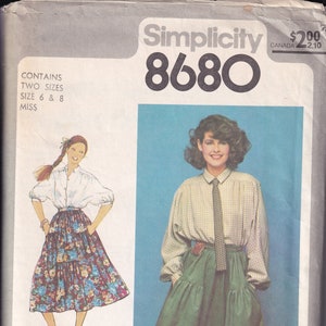 May include: Simplicity 8680 sewing pattern envelope featuring illustrations of two different outfits. One outfit includes a white blouse and floral skirt. The other outfit includes a plaid shirt, green skirt, and brown boots. The envelope contains two sizes: 6 and 8.