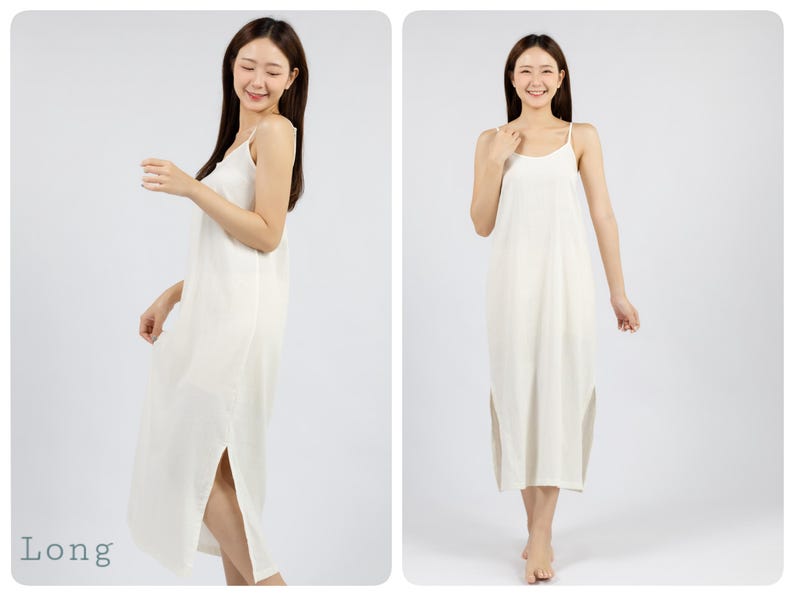 May include: A white sleeveless maxi dress with a side slit. The dress is made of a soft, flowing fabric and has a simple, elegant design. The model is wearing the dress and standing in front of a white background. The word "Long" is written in blue text at the bottom left of the image.