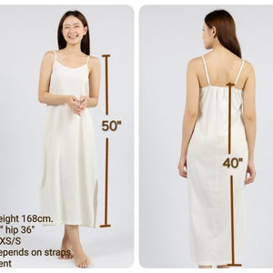 May include: White sleeveless maxi dress with adjustable straps. The dress is 50 inches long and 40 inches wide. The model is 5'6" tall and wearing a size XS/S.
