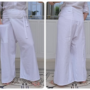 May include: White wrap pants with a wide leg and a tie at the waist. The pants are made of a lightweight fabric and have a relaxed fit.