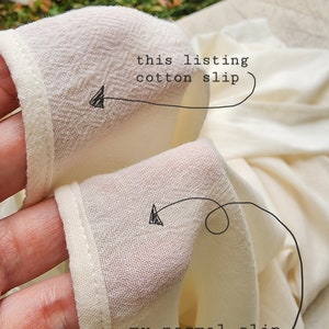 May include: Close-up of two pieces of white fabric. The top piece is labeled "this listing cotton slip" and the bottom piece is labeled "my normal slip dress".