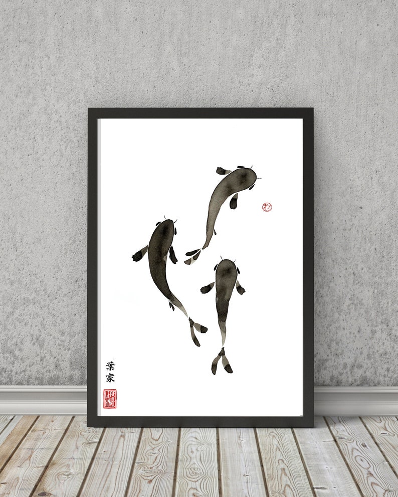 May include: A black and white ink painting of three koi fish swimming in a white background. The painting is framed in a black frame. The artist's signature is in the bottom left corner.