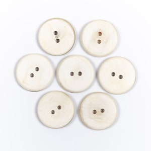 Horn buttons / size 11-50 mm. / 2 holes / Small buttons 11 mm. Large buttons 50 mm. / White buttons / Natural buffalo horn button