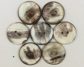 May include: Seven brown and white patterned buttons with two holes each.