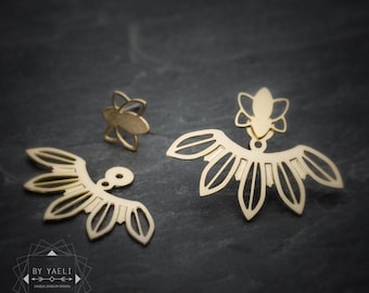 May include: Gold-toned ear jacket earrings featuring a small flower-shaped stud and a detachable fan-shaped piece with openwork petal designs. The logo BY YAELI UNIQUE JEWELRY DESIGN is visible in the bottom left corner of the image.