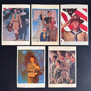 May include: Five vintage Norman Rockwell prints featuring Boy Scouts. The prints are in color and depict various scenes of Boy Scouts in different settings. The prints are framed and ready to hang.