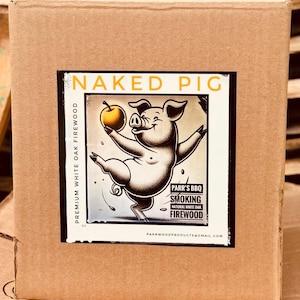 May include: A brown cardboard box with a label that says "NAKED PIG" and features a cartoon pig holding an apple. The label also includes the text "PARR'S BBQ SMOKING NATURAL WHITE OAK FIREWOOD" and "PARRWOODPRODUCTS@GMAIL.COM".