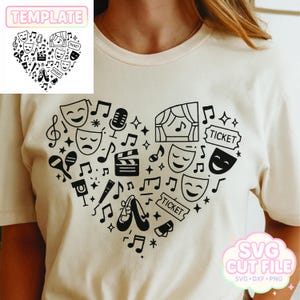 May include: A cream-coloured t-shirt with a heart-shaped design made up of theatre-related icons. The design includes musical notes, stage masks, a microphone, ballet shoes, and the word "TICKET". The shirt also has the text "TEMPLATE" and "SVG CUT FILE".