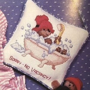 May include: A white pillow with a red-haired character in a bathtub with bubbles. The text "Sorry - No Vacancy!" is printed on the pillow.