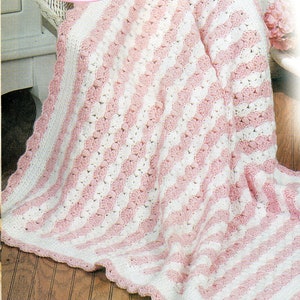 May include: A pink and white striped crocheted baby blanket with a scalloped edge.