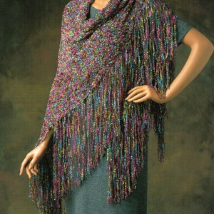 May include: A multi-colored shawl with fringe. The shawl is made of a sparkly yarn and has a crocheted design.