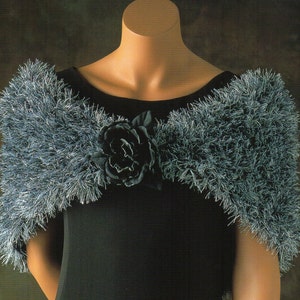 May include: A blue and silver fuzzy shawl with a black fabric rose accent.