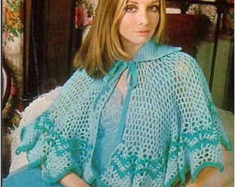 May include: A light blue crocheted cape with a scalloped edge and a tie closure. The cape features a detailed open weave design with a darker teal trim. The garment is worn over a light blue dress.