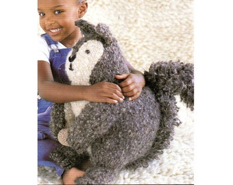 May include: A handmade, plush squirrel toy with a textured, gray body and a fluffy tail. The squirrel has a cream-colored face and a small, black nose. The toy is soft and cuddly, perfect for children.