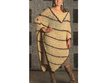 May include: A beige crochet poncho with dark brown horizontal stripes. The poncho has a V-neck and a loose, flowing design. The model is wearing brown boots and a skirt. The background is a textured gray wall.