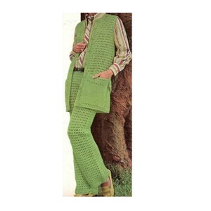 May include: A vintage, light green crochet pantsuit. The suit includes a long vest with pockets and matching pants. The person is wearing a striped shirt and tie underneath the vest. The outfit is a retro style.