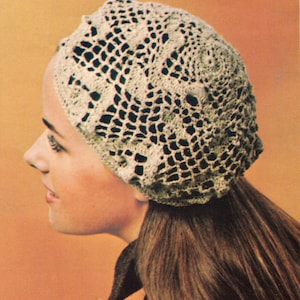 May include: A close-up of a woman wearing a crocheted beige beret with a delicate openwork pattern.
