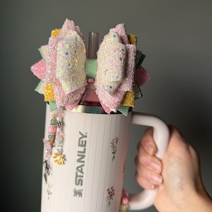 May include: A white ceramic mug with a black handle and the text "But First, Coffee" in a handwritten style. The mug is on a white surface. The mug is 4 inches tall.