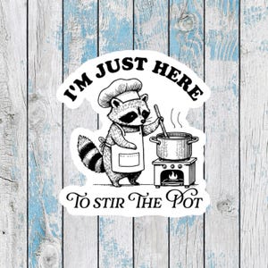 May include: A black and white illustration of a raccoon wearing a chef's hat and apron, stirring a pot on a stove. The text reads "I'm just here to stir the pot."