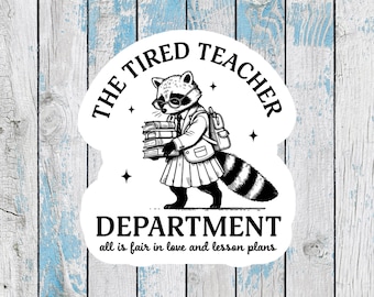 May include: A white sticker featuring a raccoon dressed as a teacher, wearing glasses and carrying books. The text reads "THE TIRED TEACHER DEPARTMENT" with the phrase "all is fair in love and lesson plans" below.