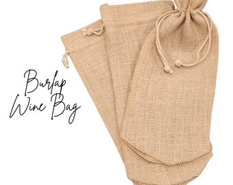 May include: Three beige burlap wine bags with drawstring closures. The bags are made of a woven fabric and are designed to hold wine bottles. The text "Burlap Wine Bag" is written in a cursive font.